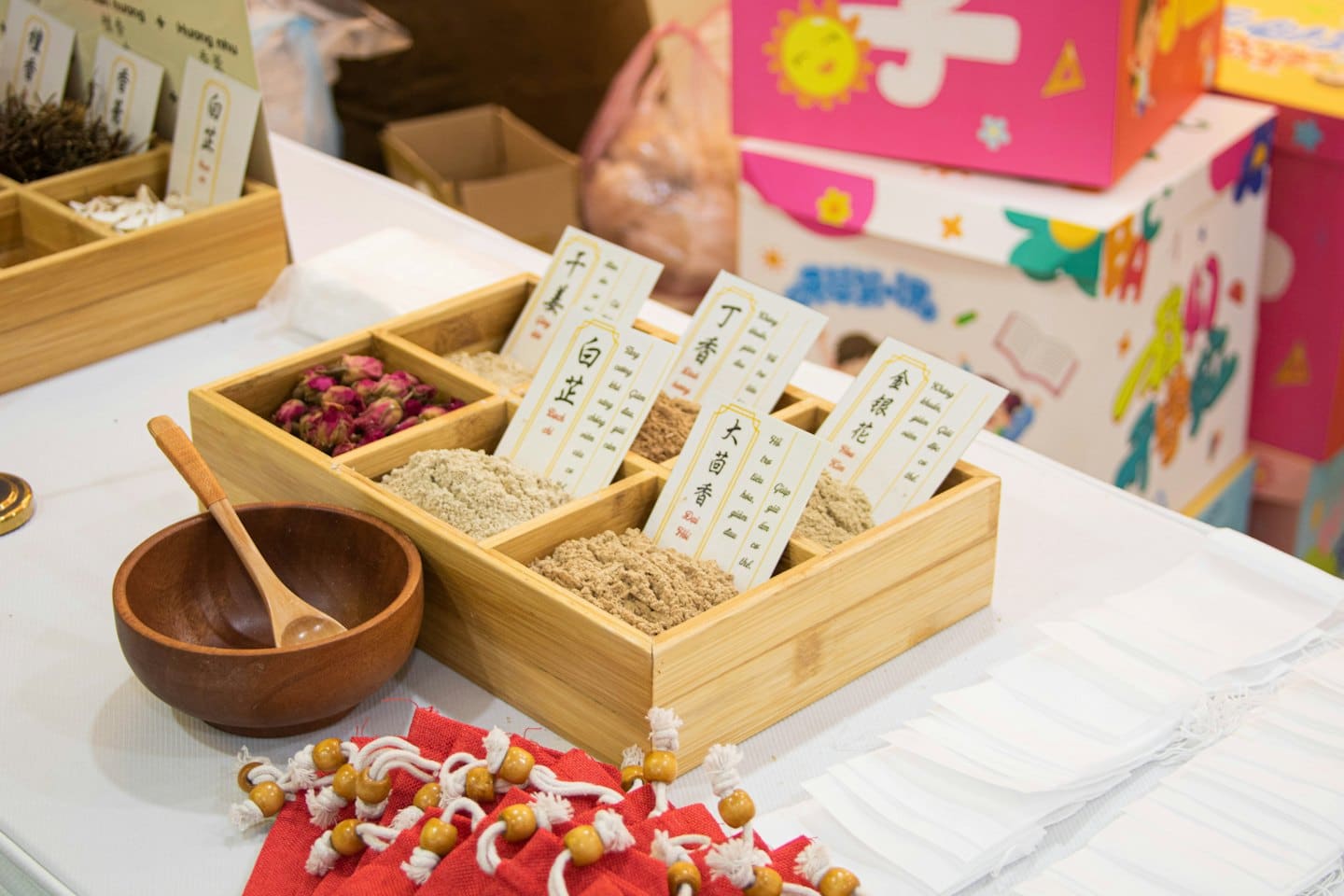 Dried herbs and powders in a wooden display box.